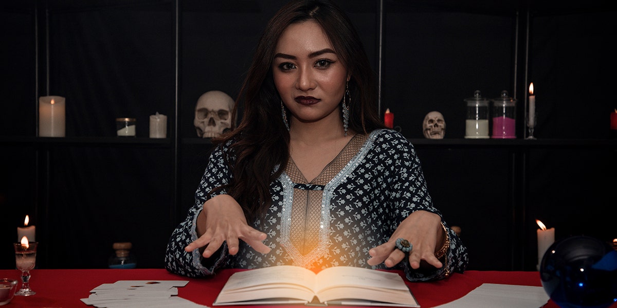 woman at table performing psychic reading