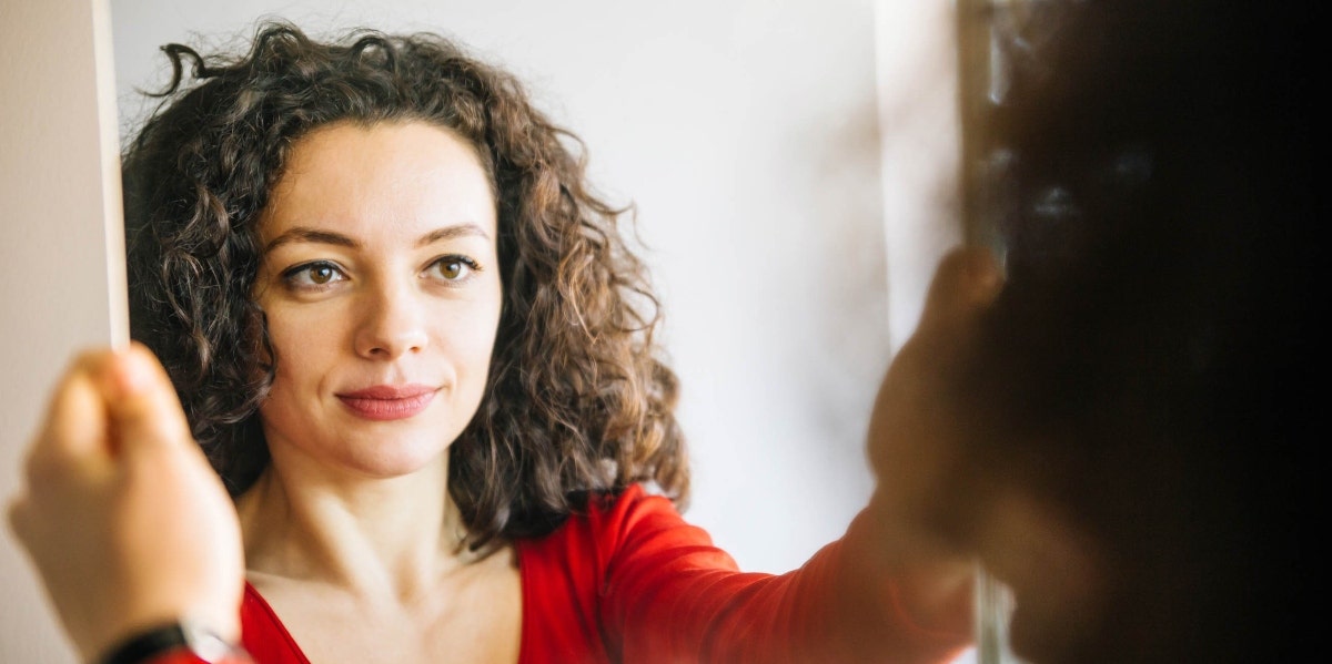 woman looking in the mirror