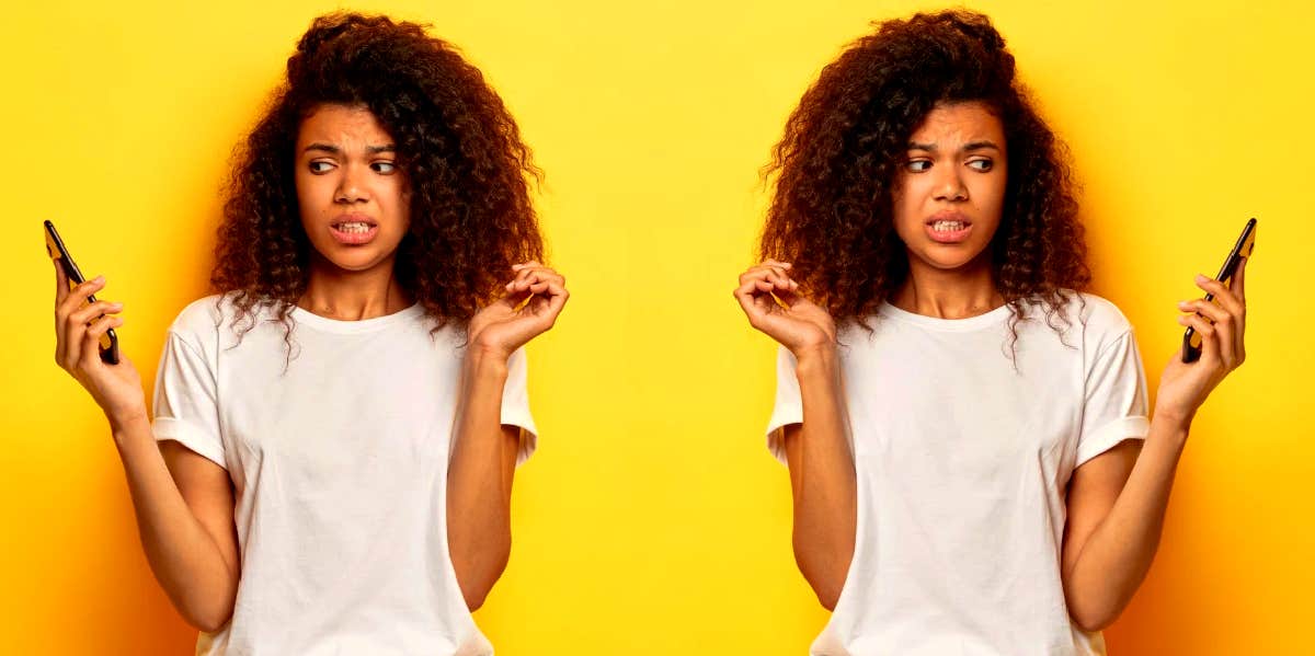 woman looking at her phone not wanting to answer