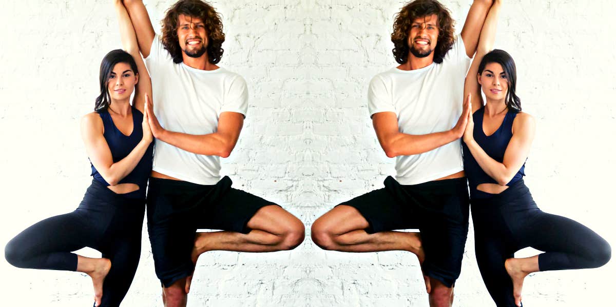 smiling man and woman in yoga pose