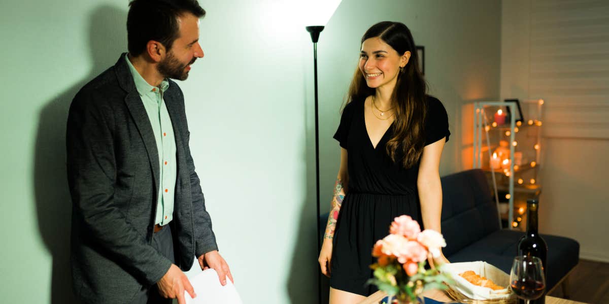 Charming Ways To Be More Chivalrous — For Deeper, More Authentic Relationships man pulling out char for woman on dinner date