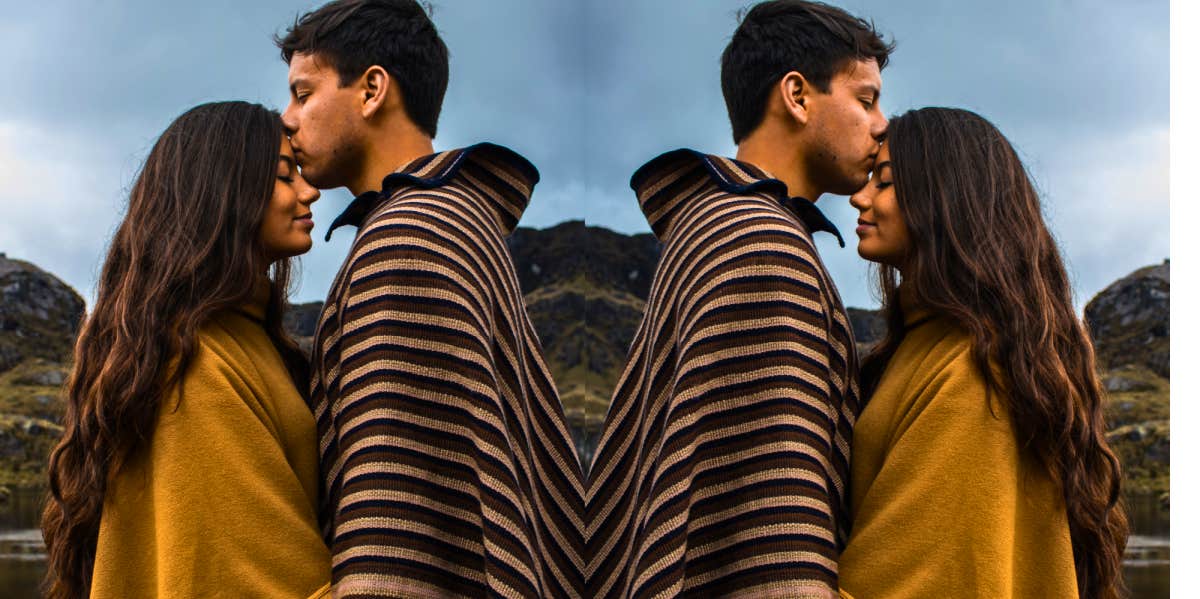 How To Be More Empathic In A Relationship empathetic couple standing together with the man kissing the woman's head