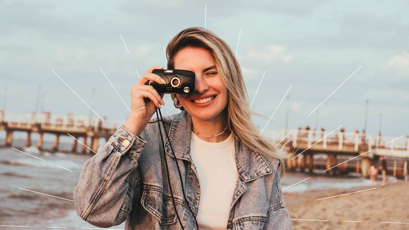 Happy woman, taking a photo with her camera