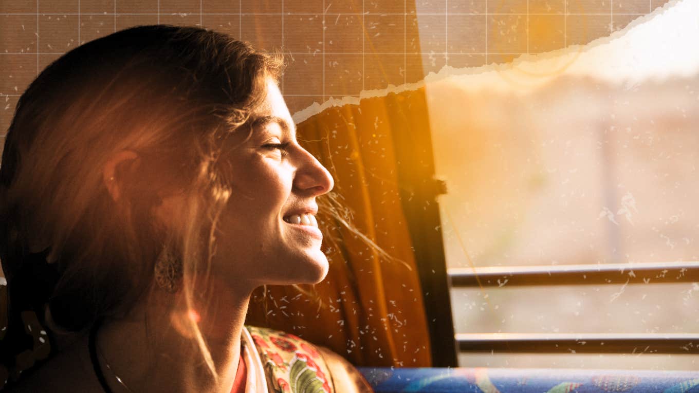 Woman looking at the sun out of her window