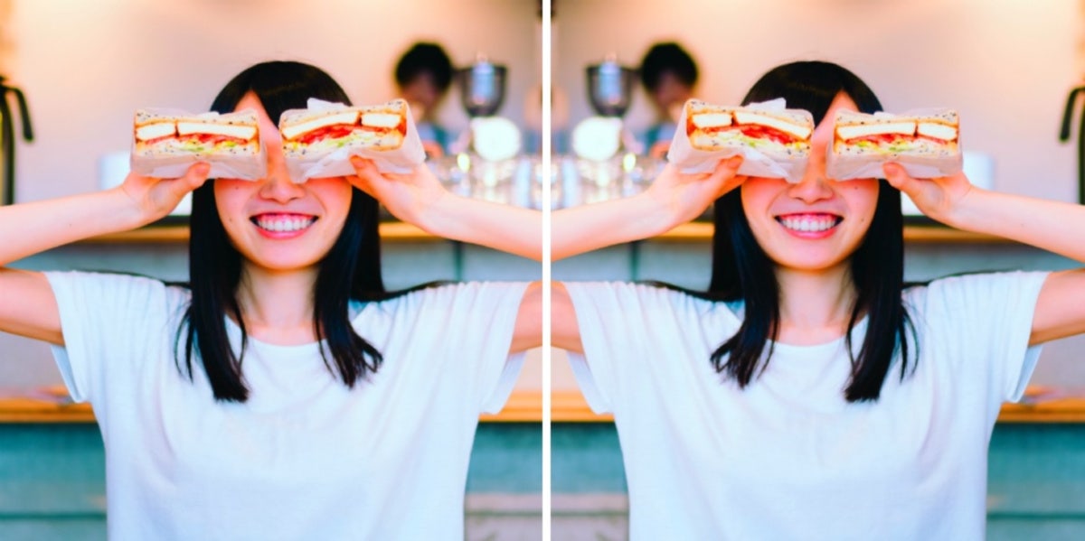 woman smiling with sandwiches for eyes