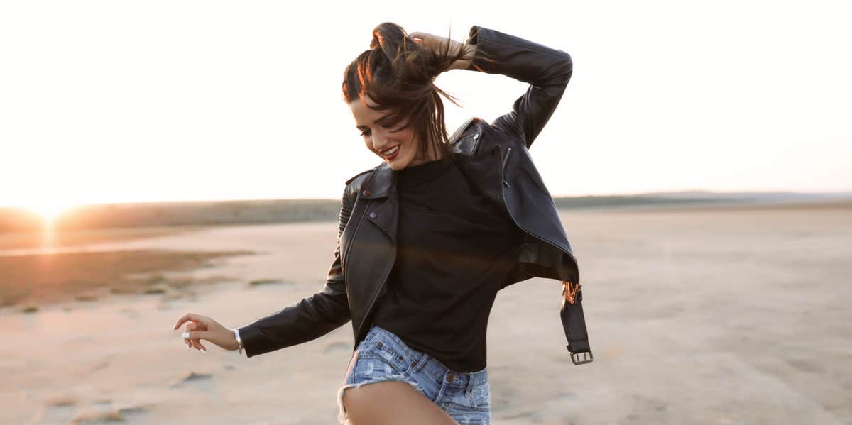 woman in leather jacket feeling herself