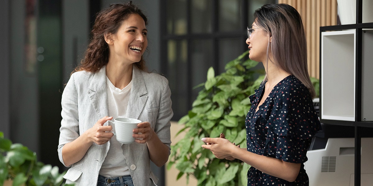 4 Words That Instantly Make You Seem More Polite two women chatting with each other