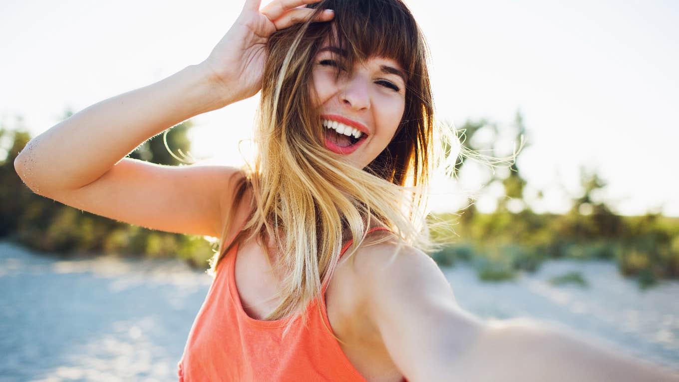 happy woman taking a photo of herself