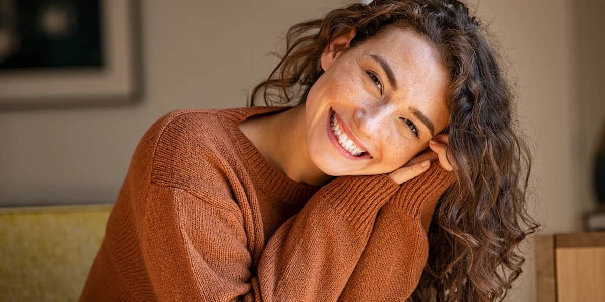 4 Scientific Ways To Become More Charming woman with curly hair smiling