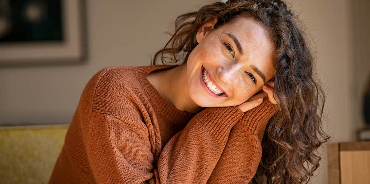 woman with curly hair smiling