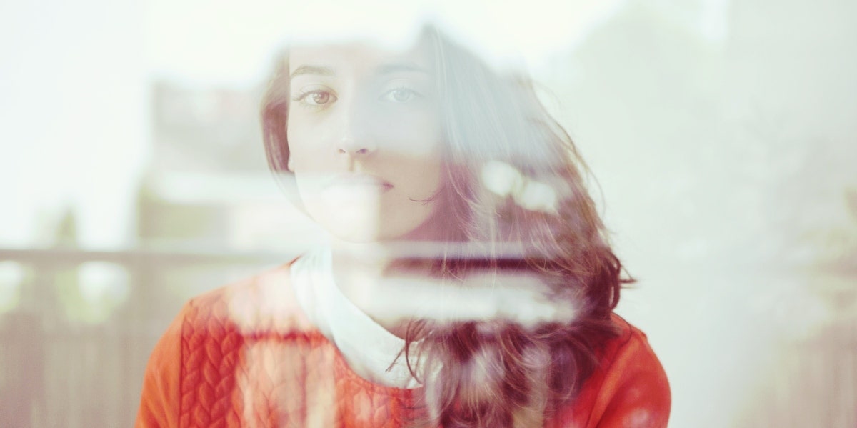 woman looking through glass window