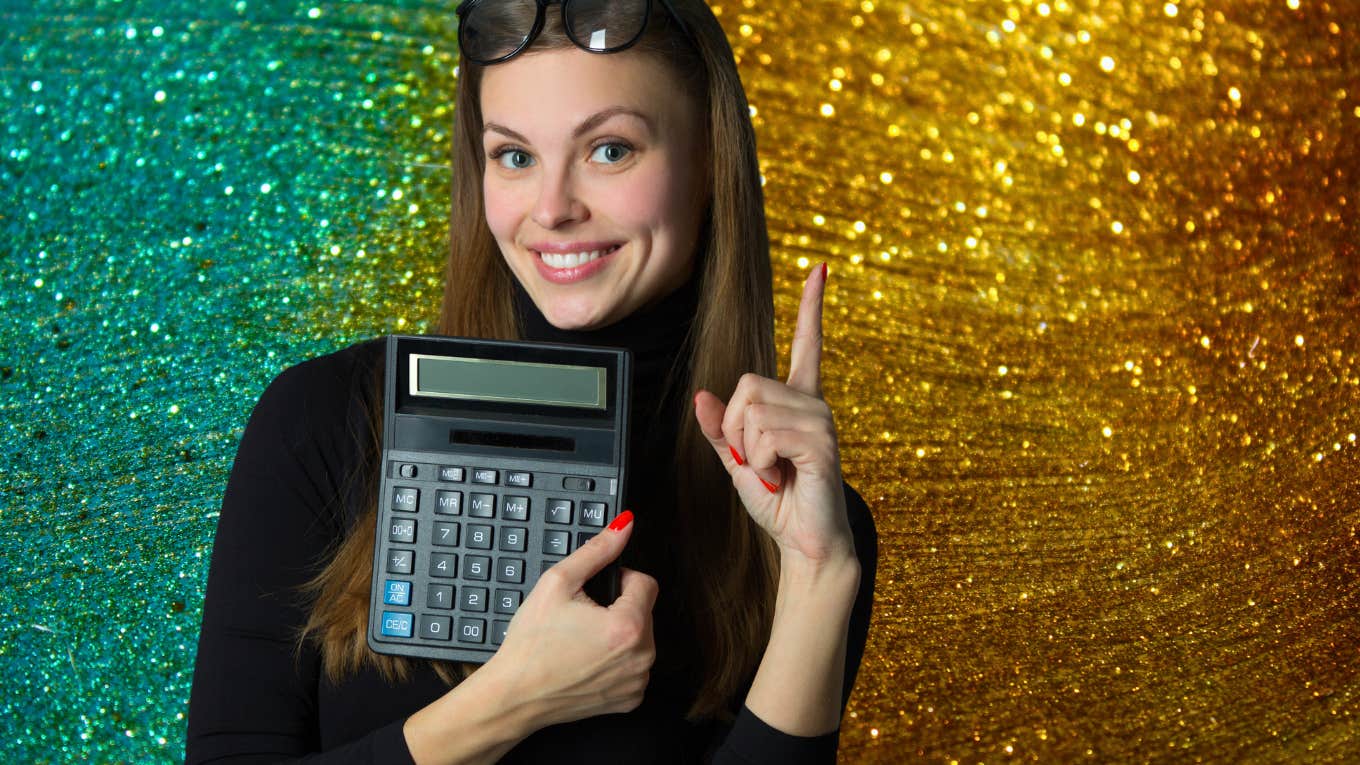beautiful woman smiling holding calculator