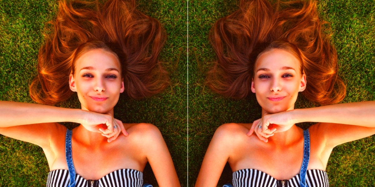 mirrored image of happy woman lying on the grass
