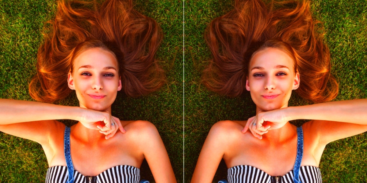 mirrored image of happy woman lying on the grass
