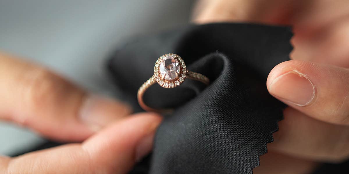 person cleaning diamond ring