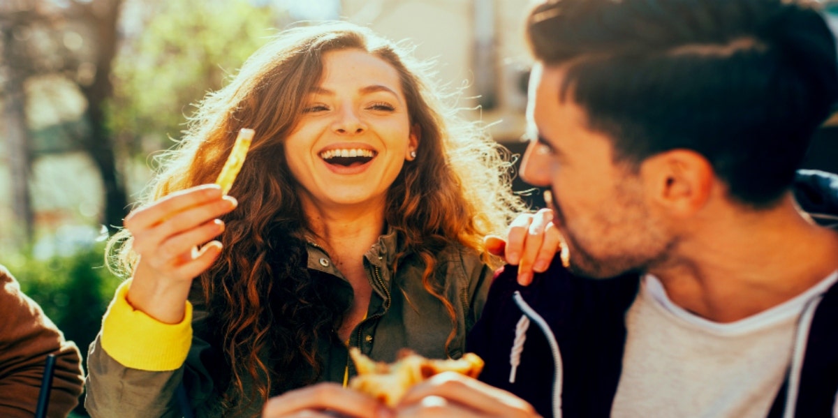 How To Date In A Pandemic: Why Slow & Steady Is The “New Normal” man and woman eating and flirting