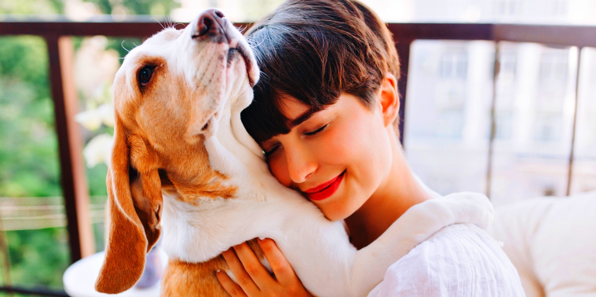 woman hugging dog 