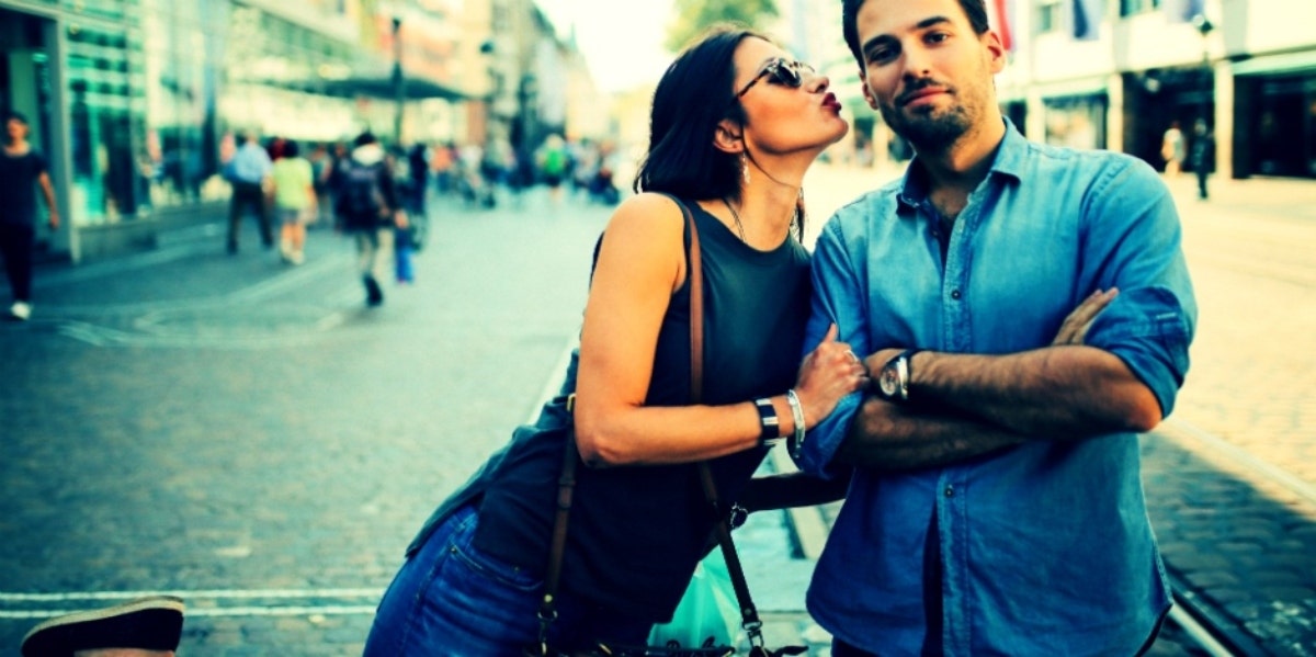 woman leaning over to kiss negative spouse