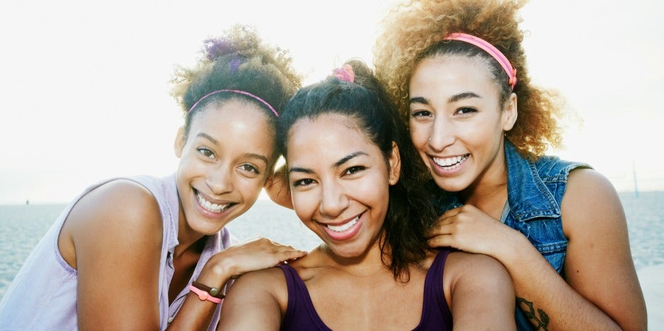 three siblings posing together