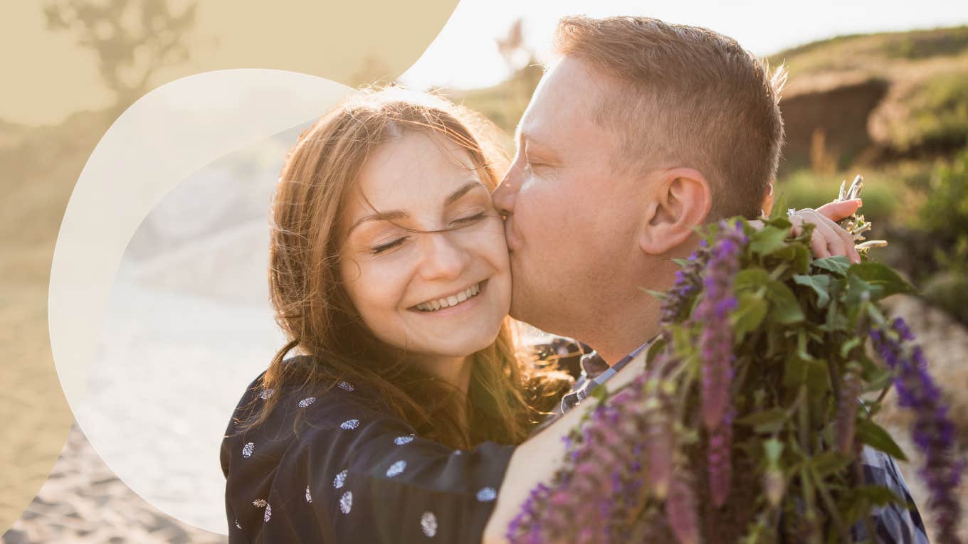 couple on the beach, man kissing her cheek