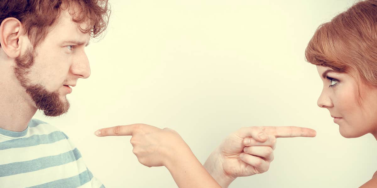 How To Solve Any Relationship Problem Without Breaking Up A couple stare at each other and point the finger at one another