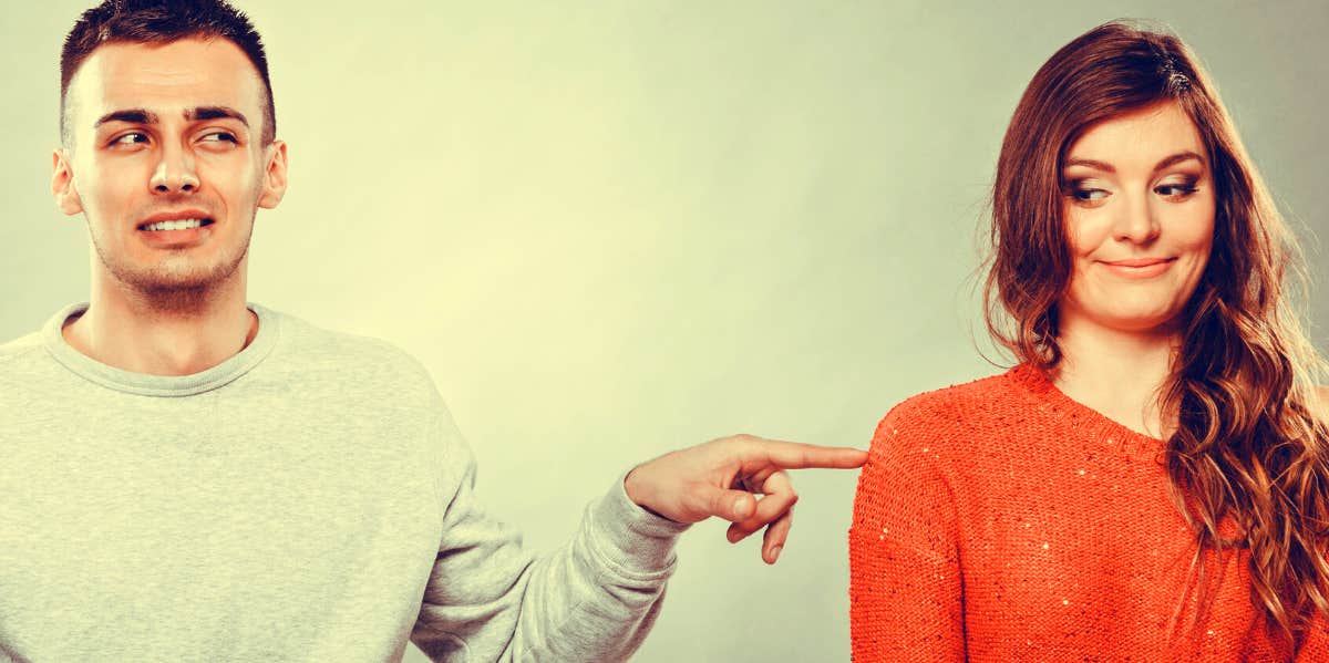 Shy woman and man sitting on sofa couch next each other