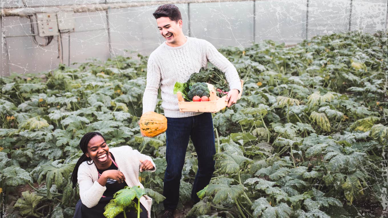 Flirty couple picking food in the garden 