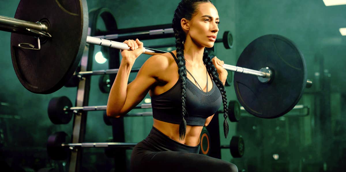 How To Get A Bigger Butt: 32 Exercises & Tips To Firm Up Your Butt Naturally Woman doing barbell squats