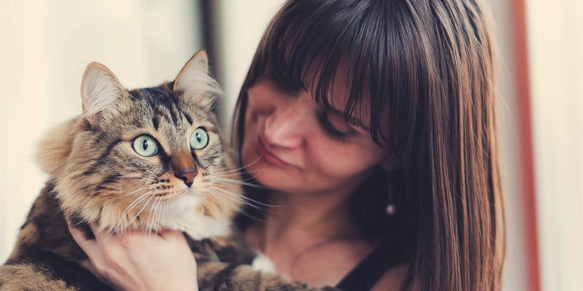 woman holding cat