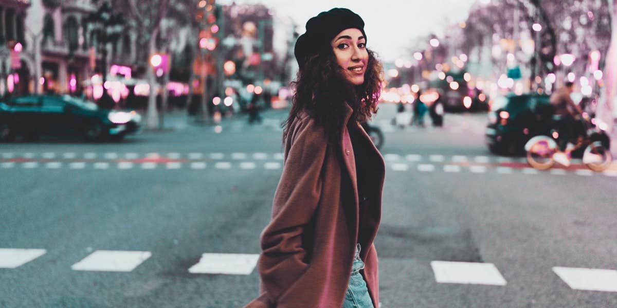 woman walking down the street smiling