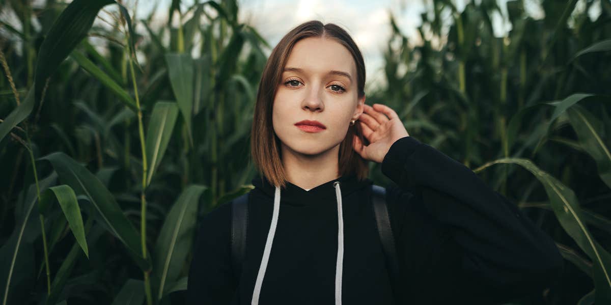 girl walking through corn field