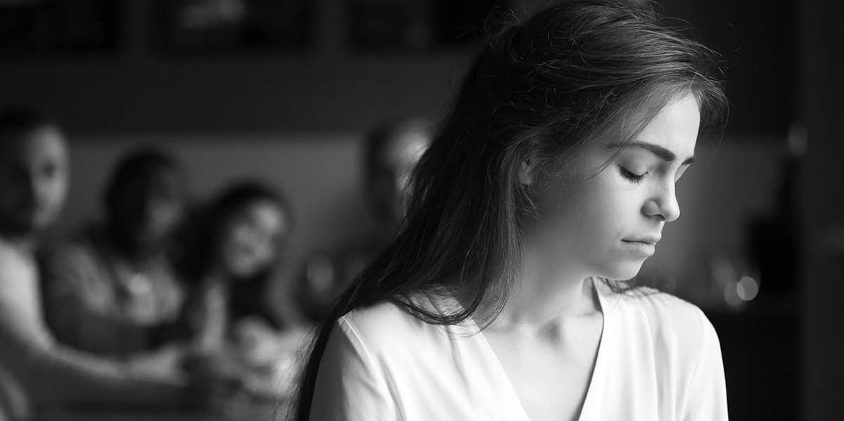 How To Survive A Breakup When You Have Mutual Friends sad woman with friends in background