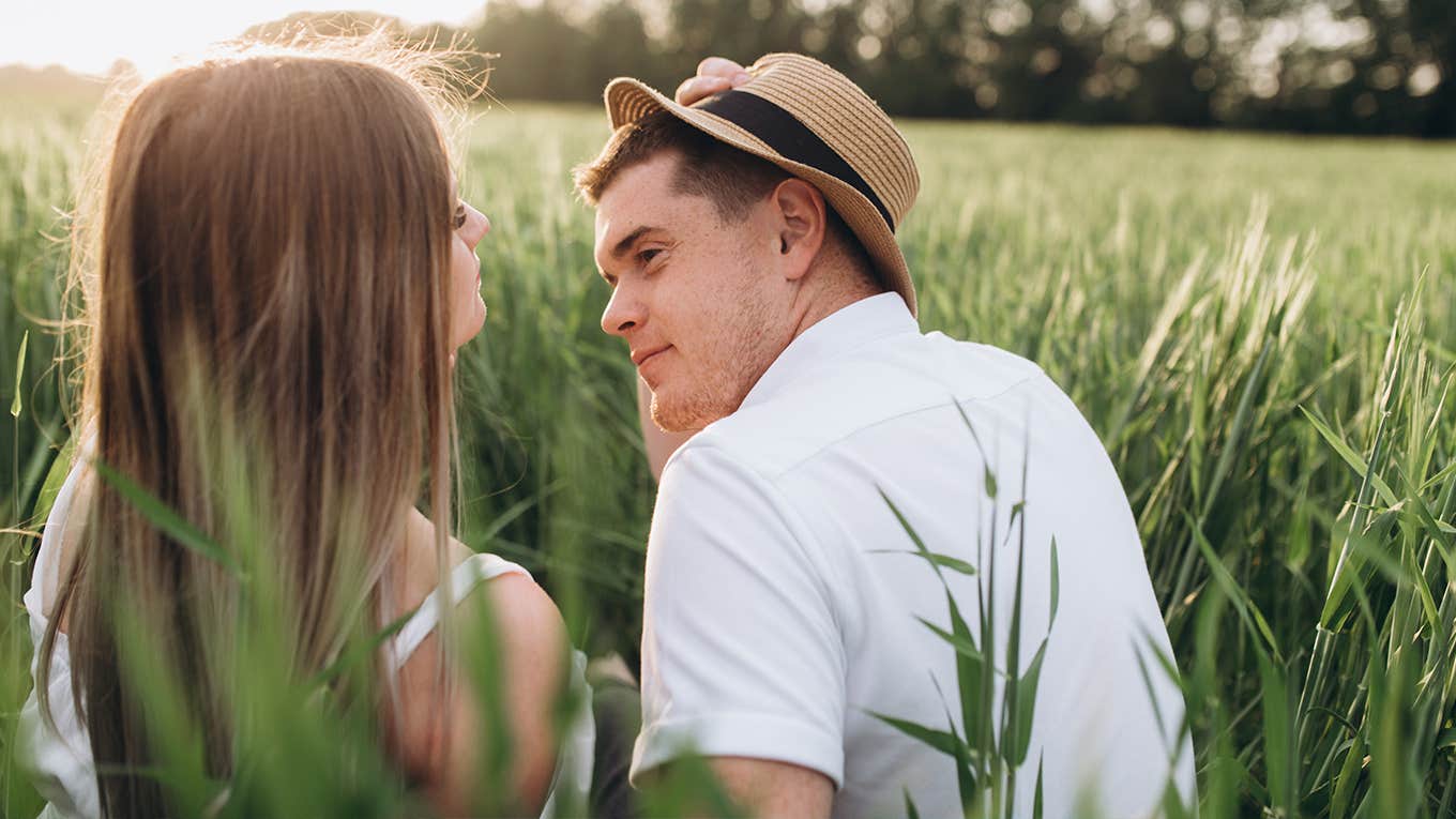 man and woman sitting on the grass