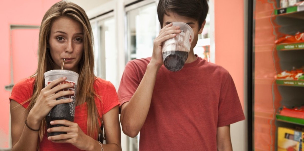 couple drinking large sodas