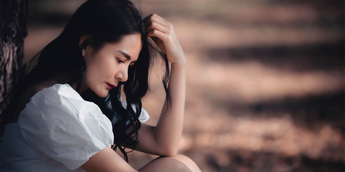 If You're Heartbroken Over Your Divorce, You Need To Hear This Advice woman sitting thinking