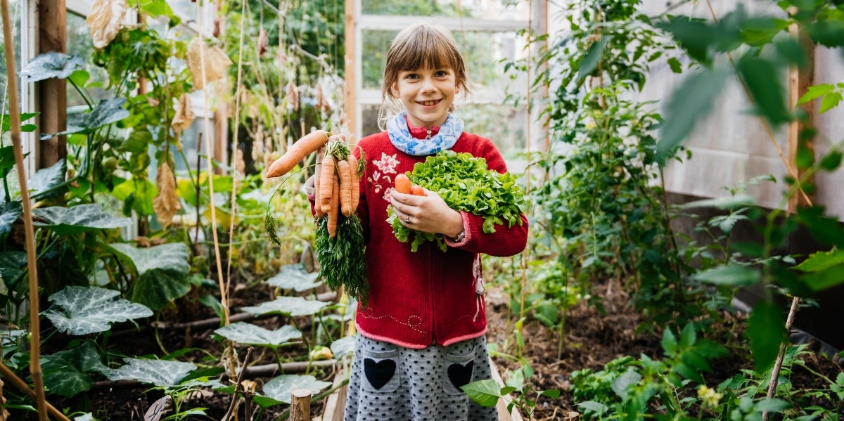 smiling girl holding carrots