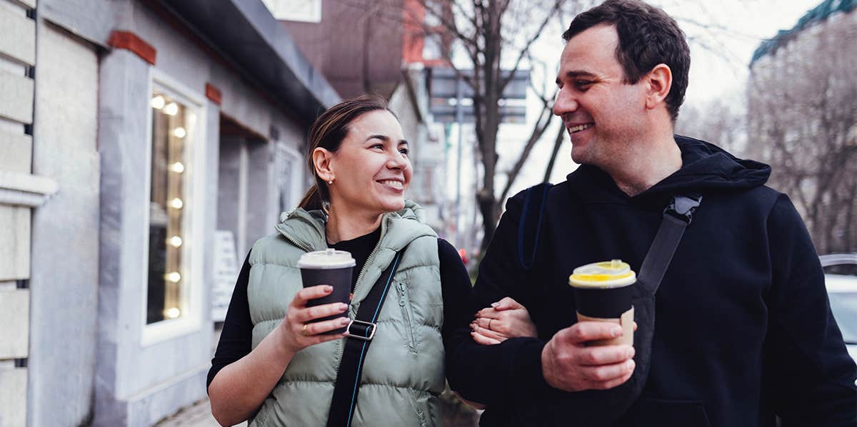 couple walking together on sidewalk chatting