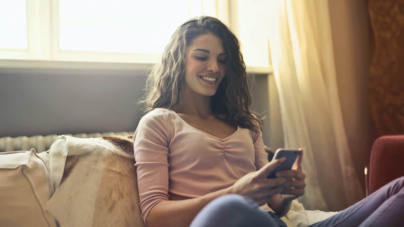 How To Keep A Man Interested Over Text With 5 Easy Strategies smiling woman texting