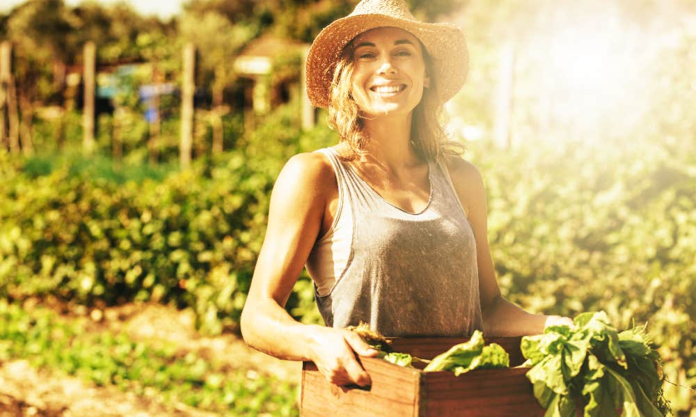 How To Keep Rabbits Out Of Your Garden — 4 Simple Tips Smiling woman with produce harvest from garden