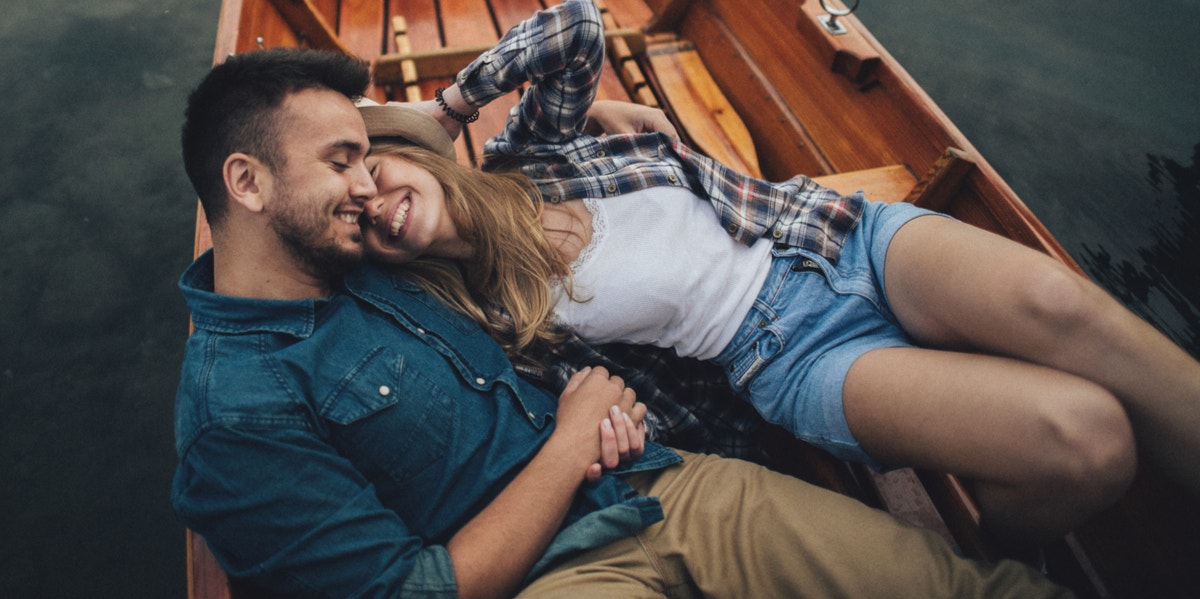 man and woman laying in boat