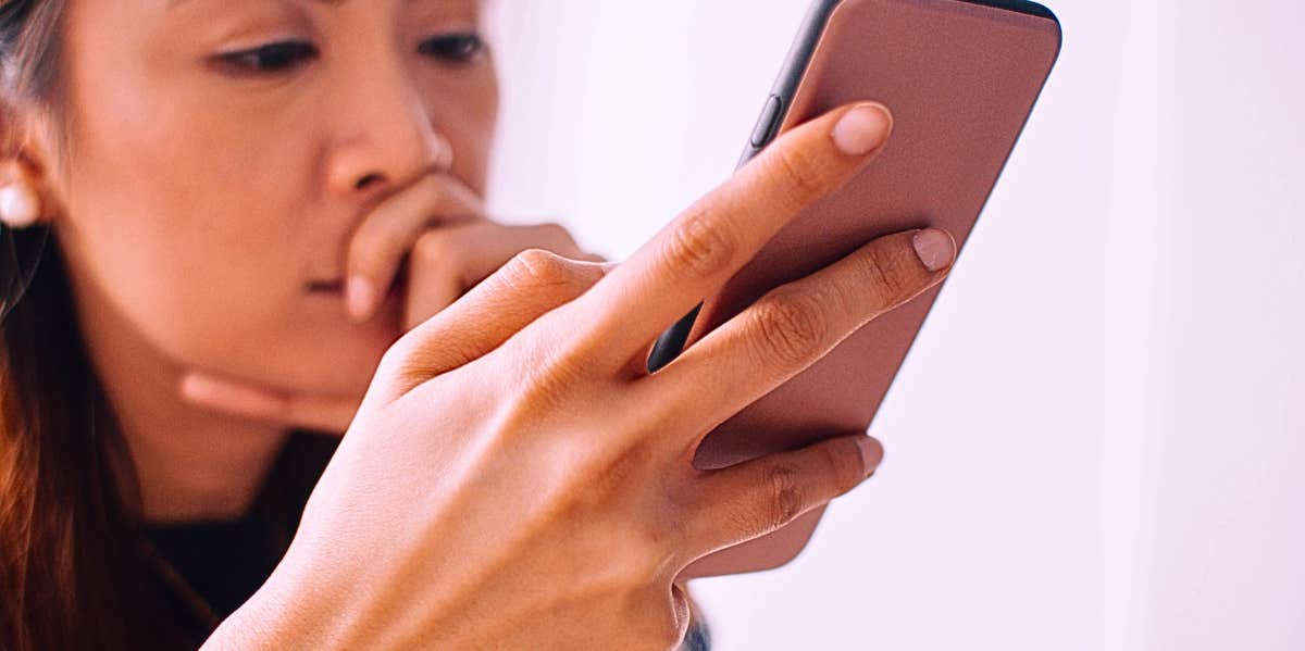 woman looking through phone trying to figure out if someone went through it