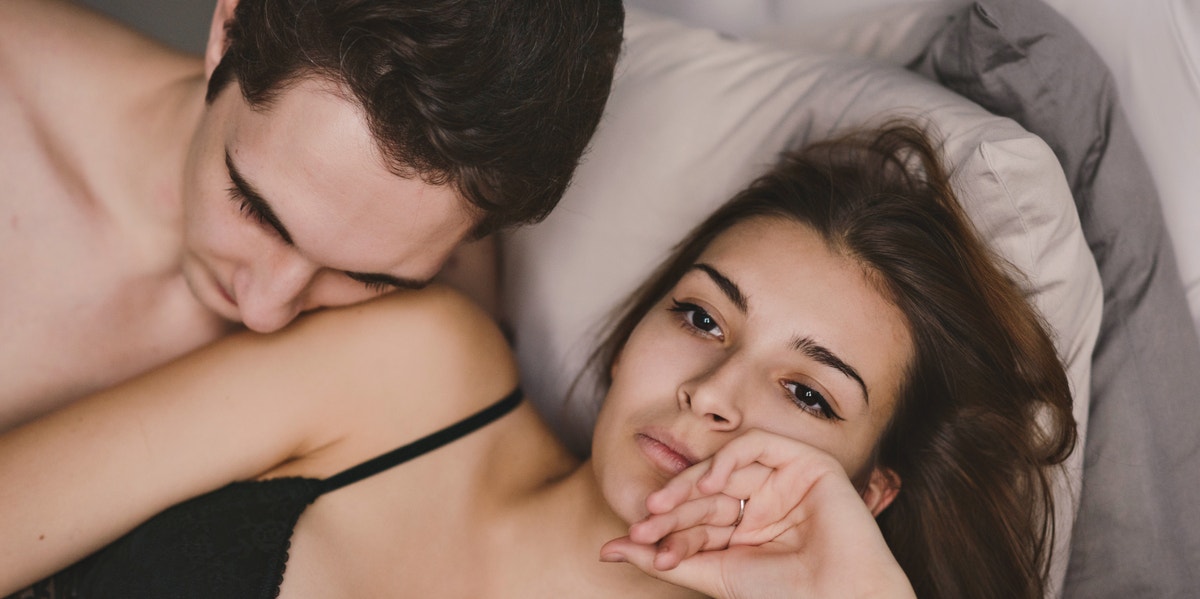 unhappy couple in bed