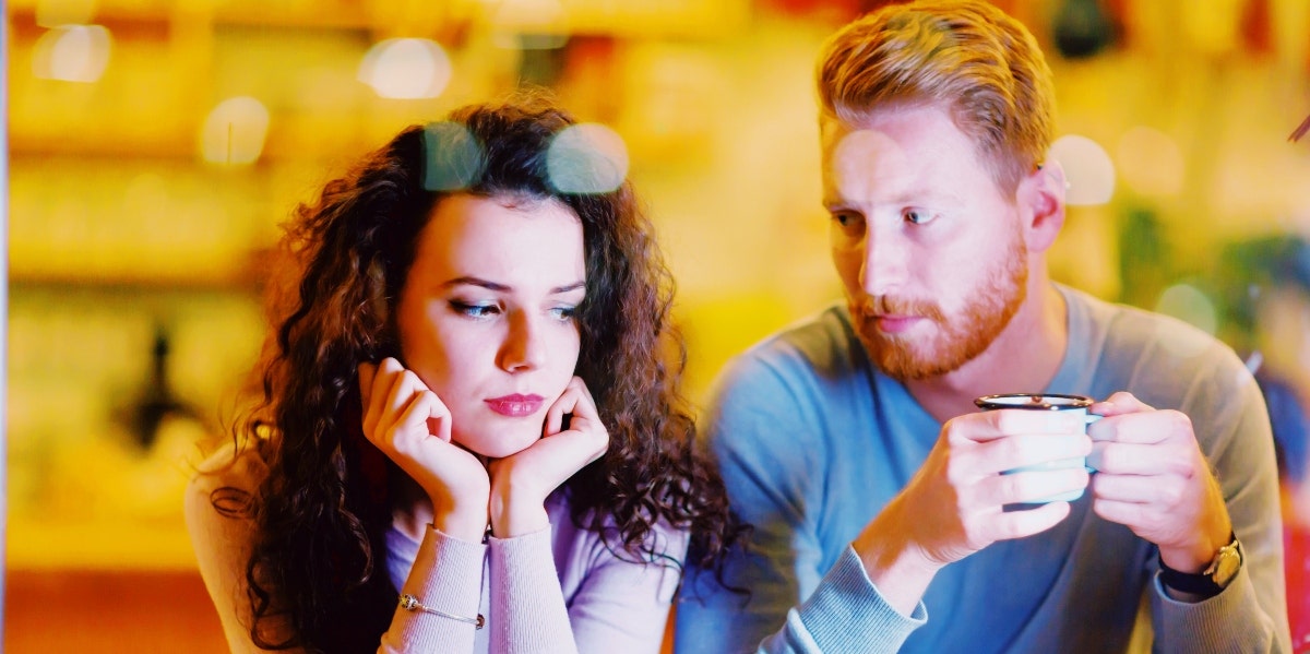 how to know you're in the wrong relationship sad-looking couple having coffee