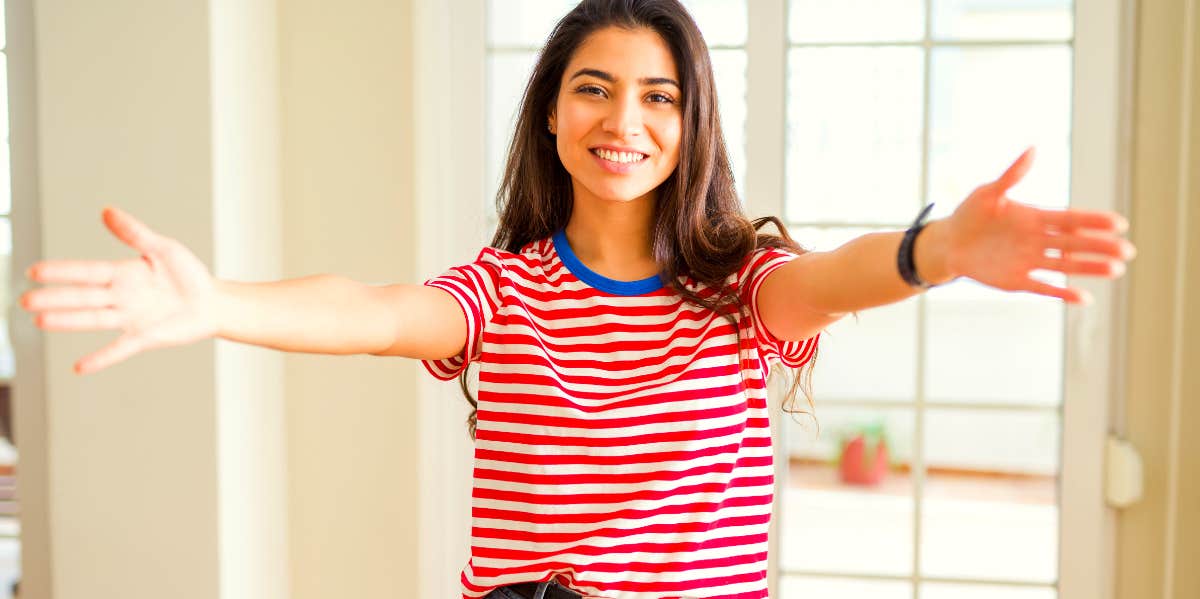 woman holding her arms wide open