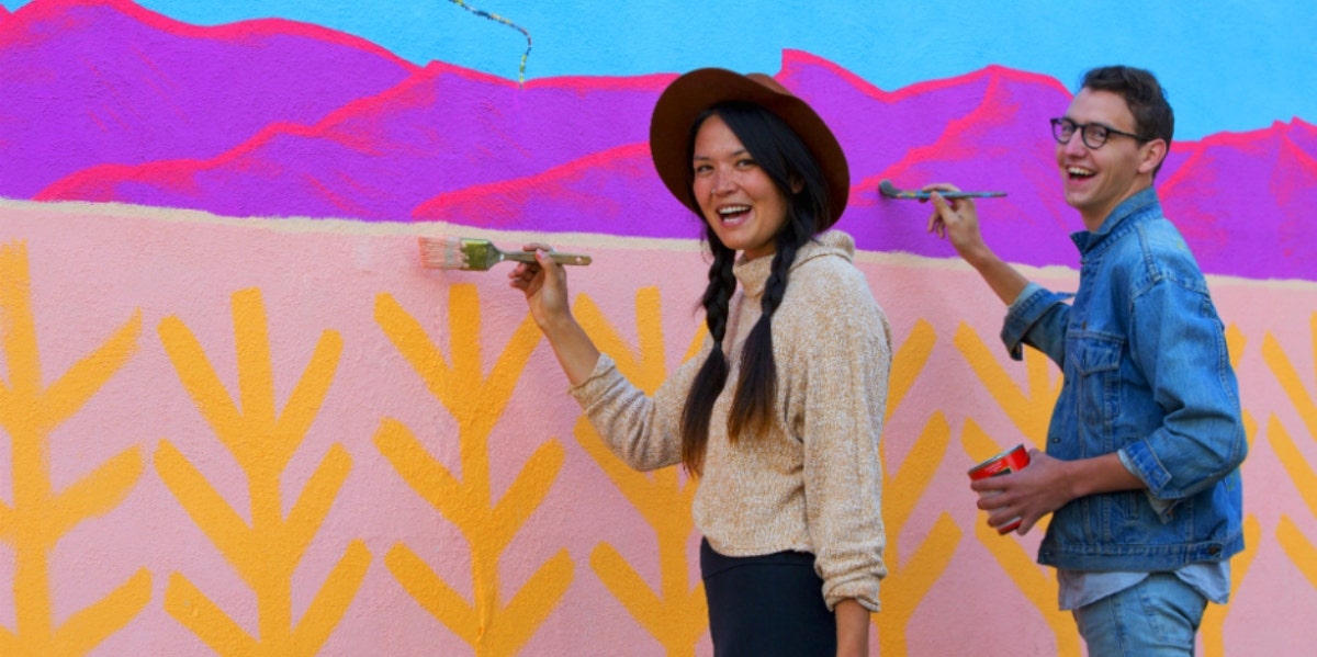 man and woman painting a wall