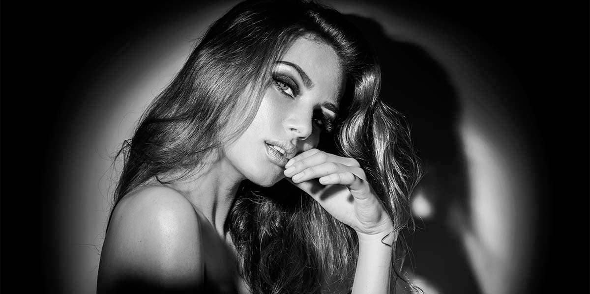 How To Love A Sagittarius Woman — 7 Ways To Treat Her Right black and white photo of woman