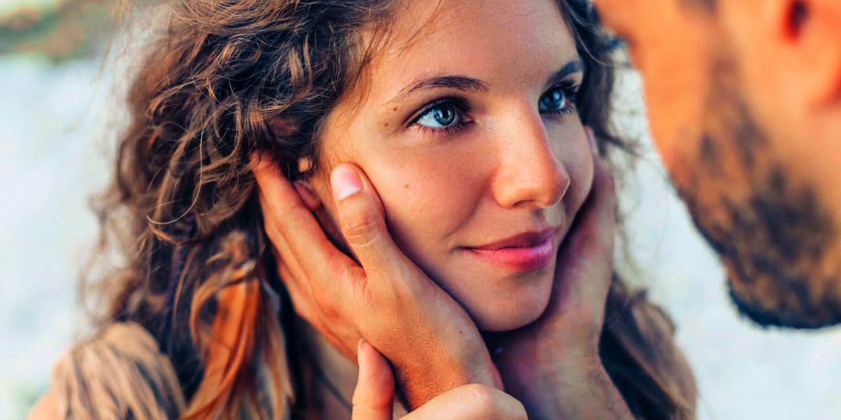 man holding woman's face close