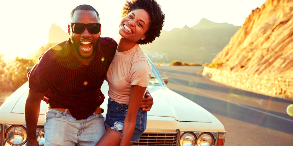 How To Make A Man Crazy About You smiling couple standing in front of their car