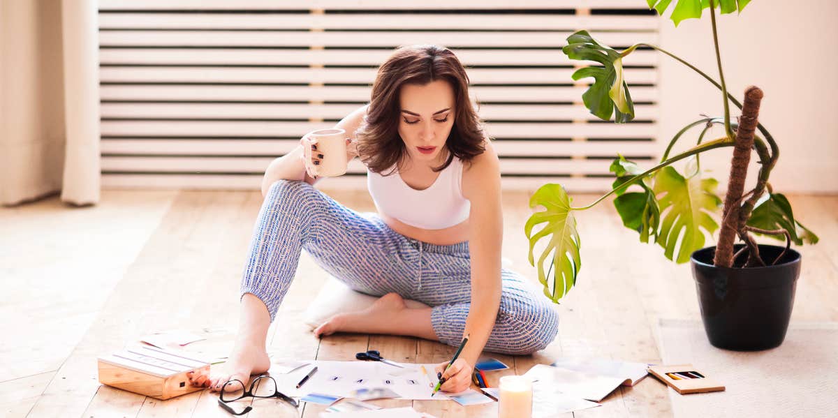 woman on floor making a vision board