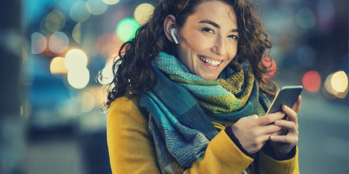 Woman smiling and sending message